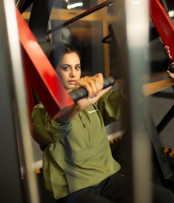 Woman in a calm, focused pose during a light cardio workout.